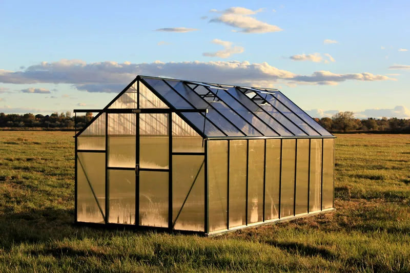 grandio greenhouse in a field with a clear sky