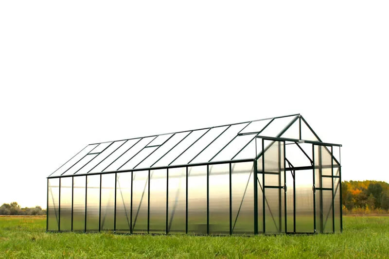 Glass greenhouse in a field with a white background